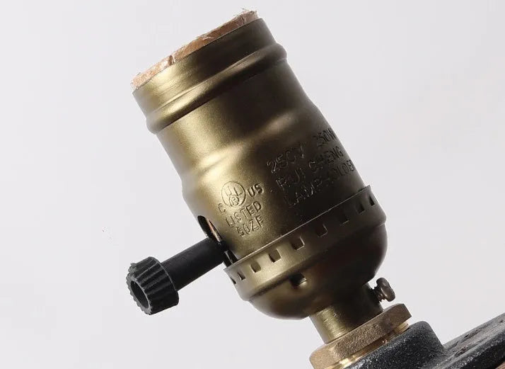 Compact water pipe design table lamp made from wood and iron on a wooden surface.