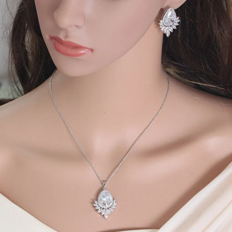 Women's formal jewellery set with necklace and bracelet in blue, red, or white with cubic zirconia stones.