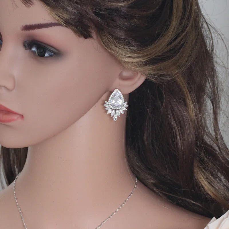 Women's formal jewellery set with necklace and bracelet in blue, red, or white with cubic zirconia stones.