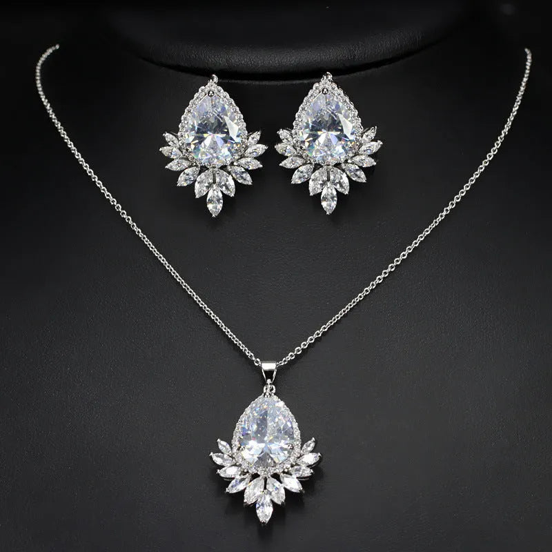 Women's formal jewellery set with necklace and bracelet in blue, red, or white with cubic zirconia stones.