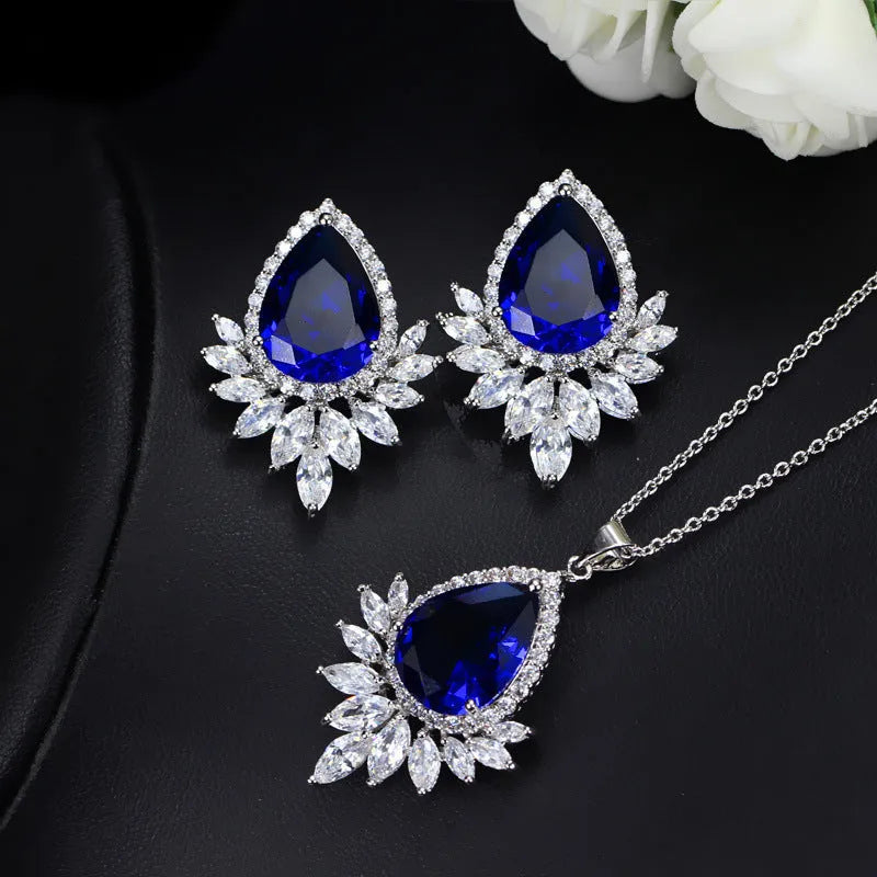Women's formal jewellery set with necklace and bracelet in blue, red, or white with cubic zirconia stones.
