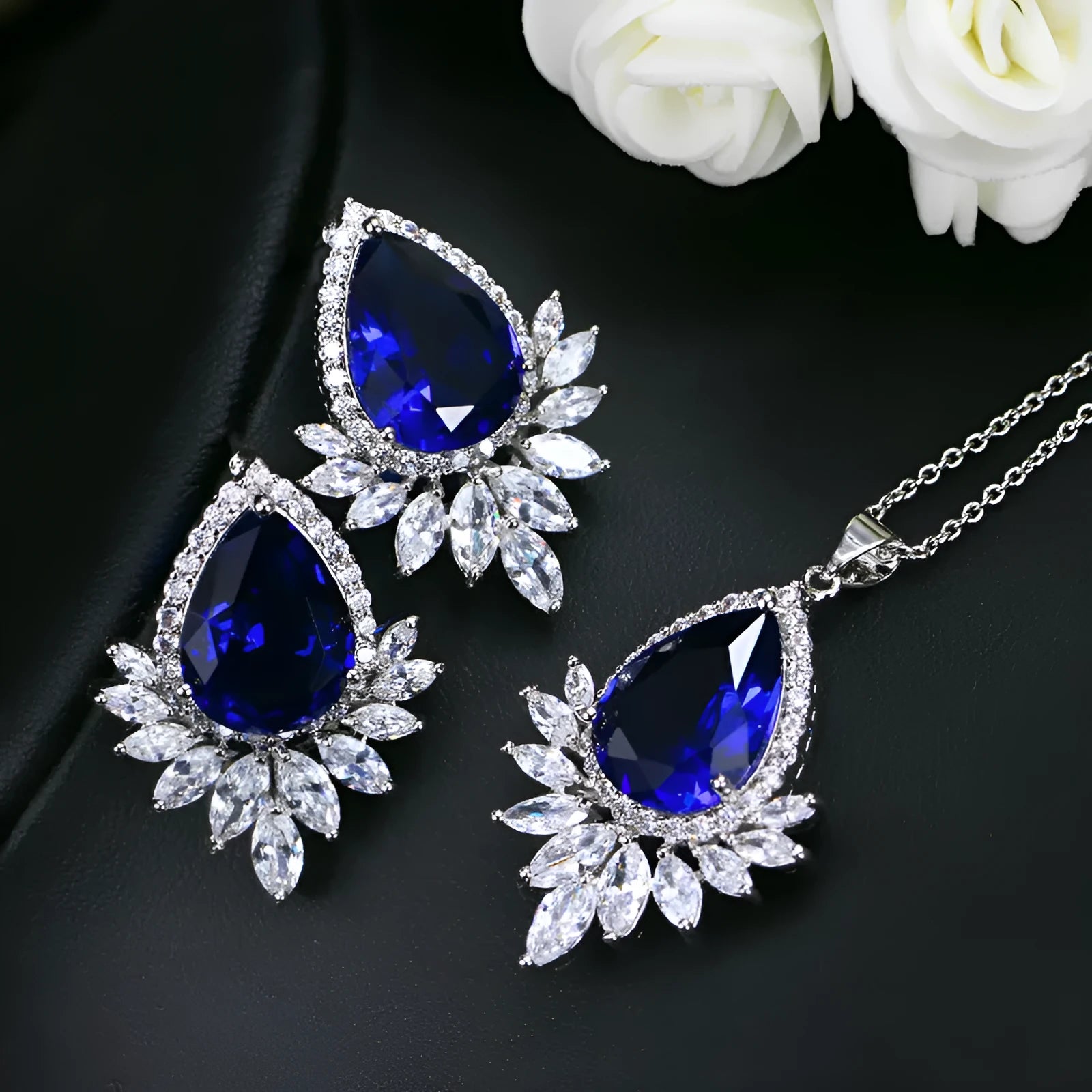 Women's formal jewellery set with necklace and bracelet in blue, red, or white with cubic zirconia stones.