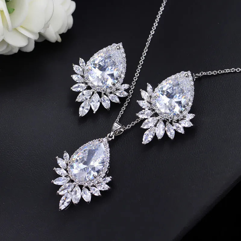Women's formal jewellery set with necklace and bracelet in blue, red, or white with cubic zirconia stones.