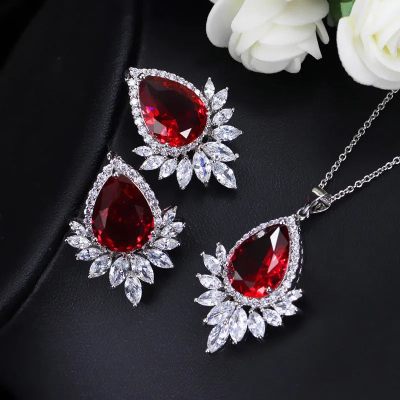 Women's formal jewellery set with necklace and bracelet in blue, red, or white with cubic zirconia stones.