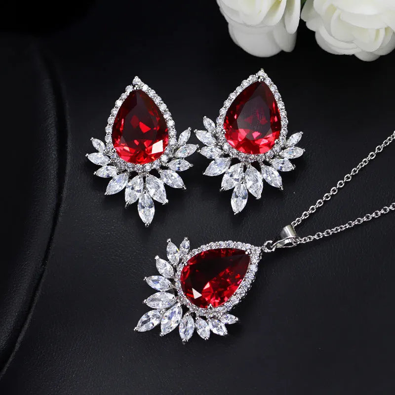 Women's formal jewellery set with necklace and bracelet in blue, red, or white with cubic zirconia stones.