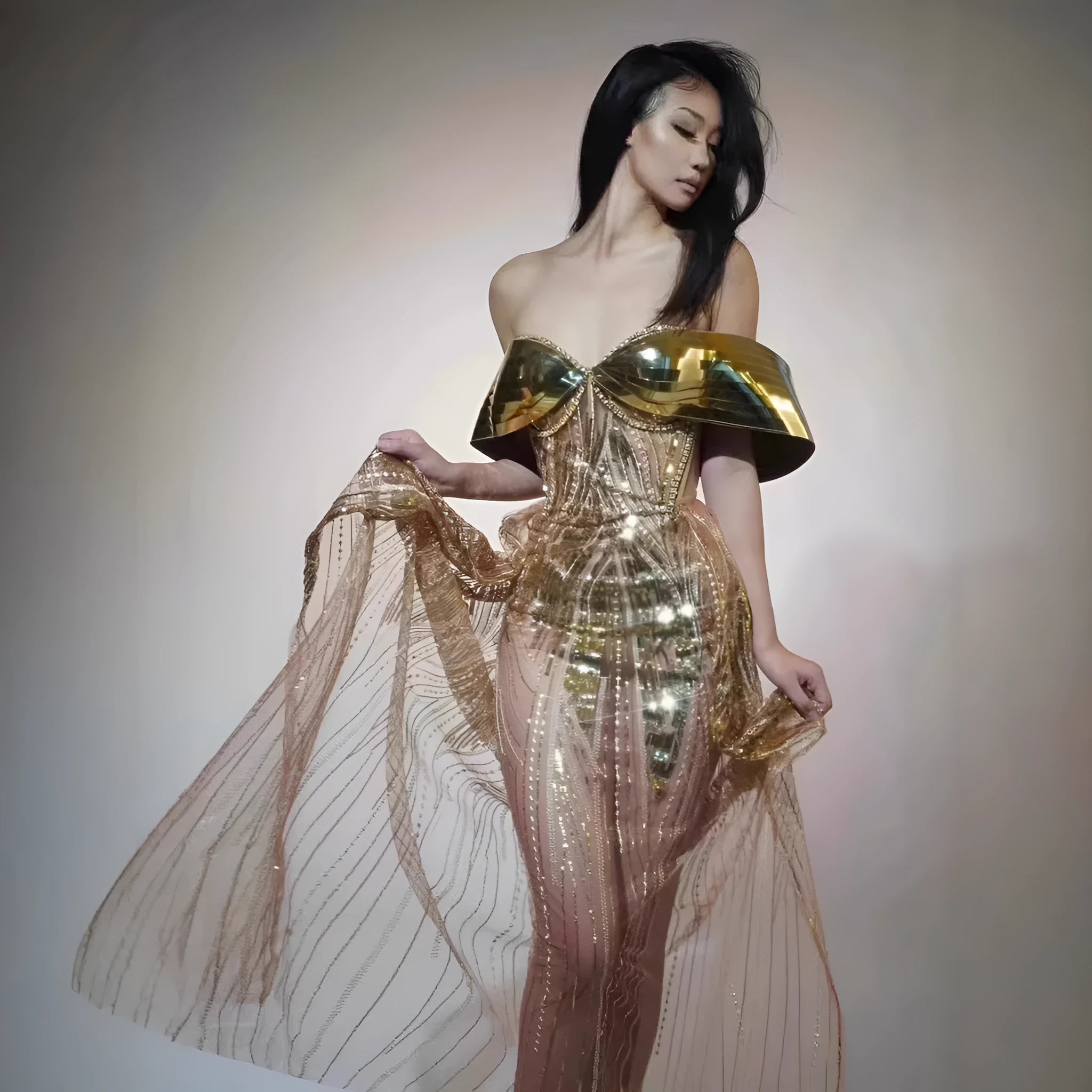 Gold sequined strapless long dress with a tulle skirt and high side slit.