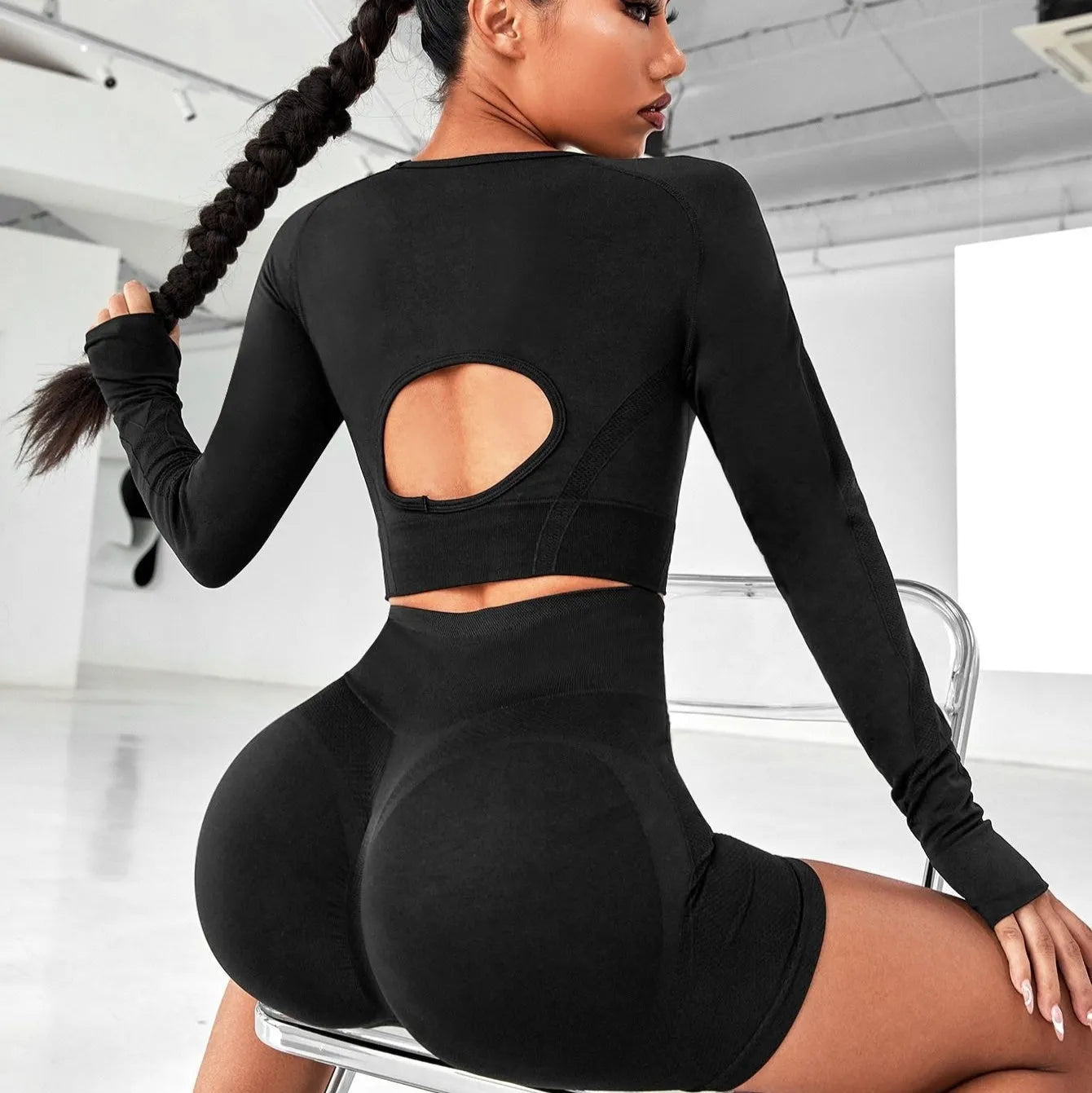Women's black yoga clothes two-piece set showing long sleeve top and high-waist tight pants.