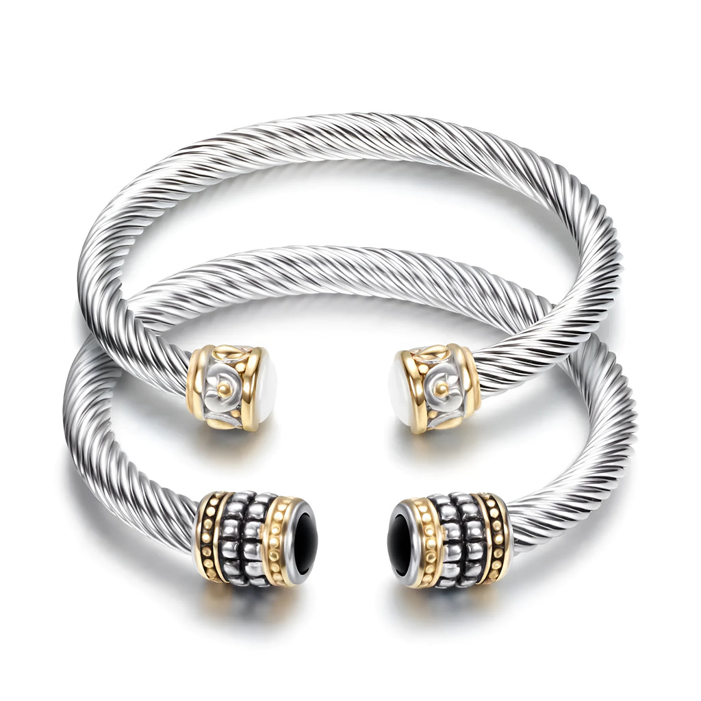 Two-tone vintage gold stainless steel bangle bracelet with black and golden finish on white background