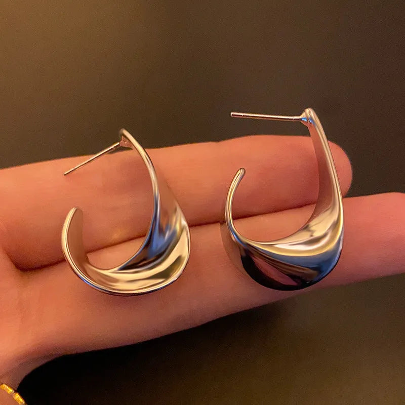 Twisted geometric metal hoop earrings in gold and silver electroplated colour options