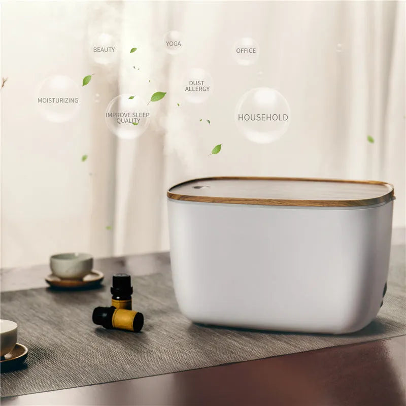 GX-22K white household atomizer humidifier and essential oil diffuser with night light on a wooden table.