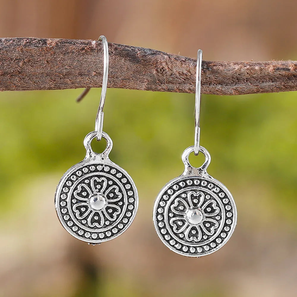 A pair of bohemian retro style earrings with a distressed geometric round print, made from electroplated zinc alloy.