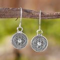 A pair of bohemian retro style earrings with a distressed geometric round print, made from electroplated zinc alloy.