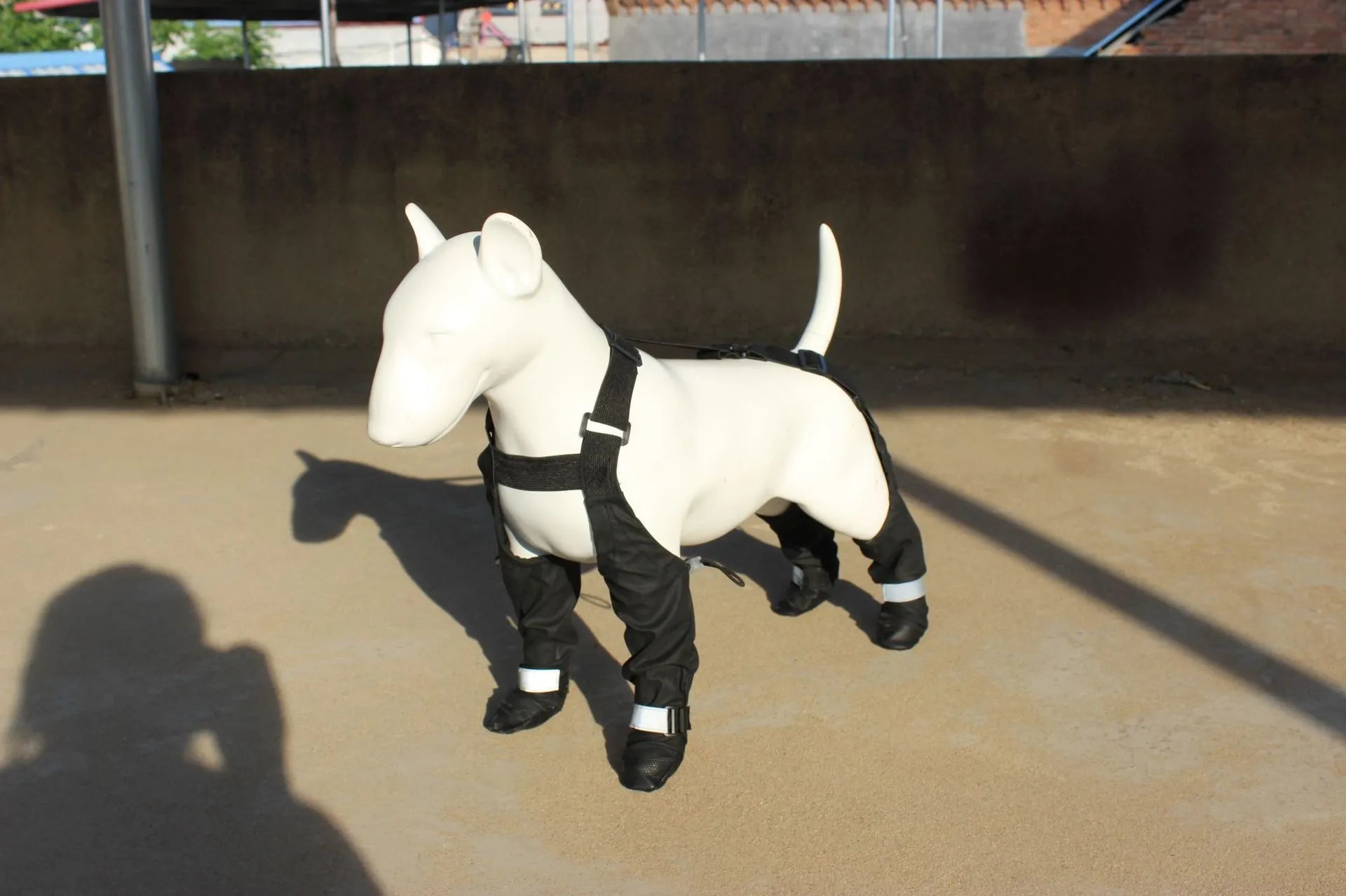 Set of four black waterproof dog shoes with non-slip soles for paw protection.