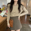 Loose fit knitted cardigan in beige, shown worn open as a long-sleeved top