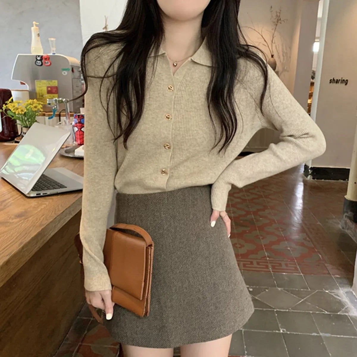 Loose fit knitted cardigan in beige, shown worn open as a long-sleeved top