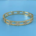 Women's hollow bracelet with zircon stones and four-leaf clover charm in gold and silver options