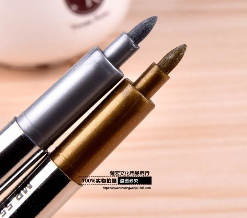 Set of two gold and silver metallic fine tip marker pens with caps on white background