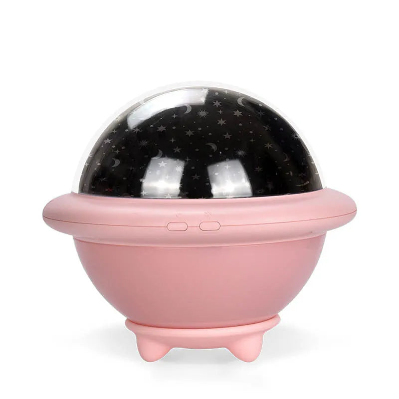 Pink UFO-shaped LED night light projecting a starry sky pattern on a wall.