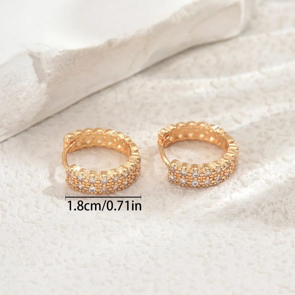 Copper geometric pattern ear studs with round, dot, and ring design elements.