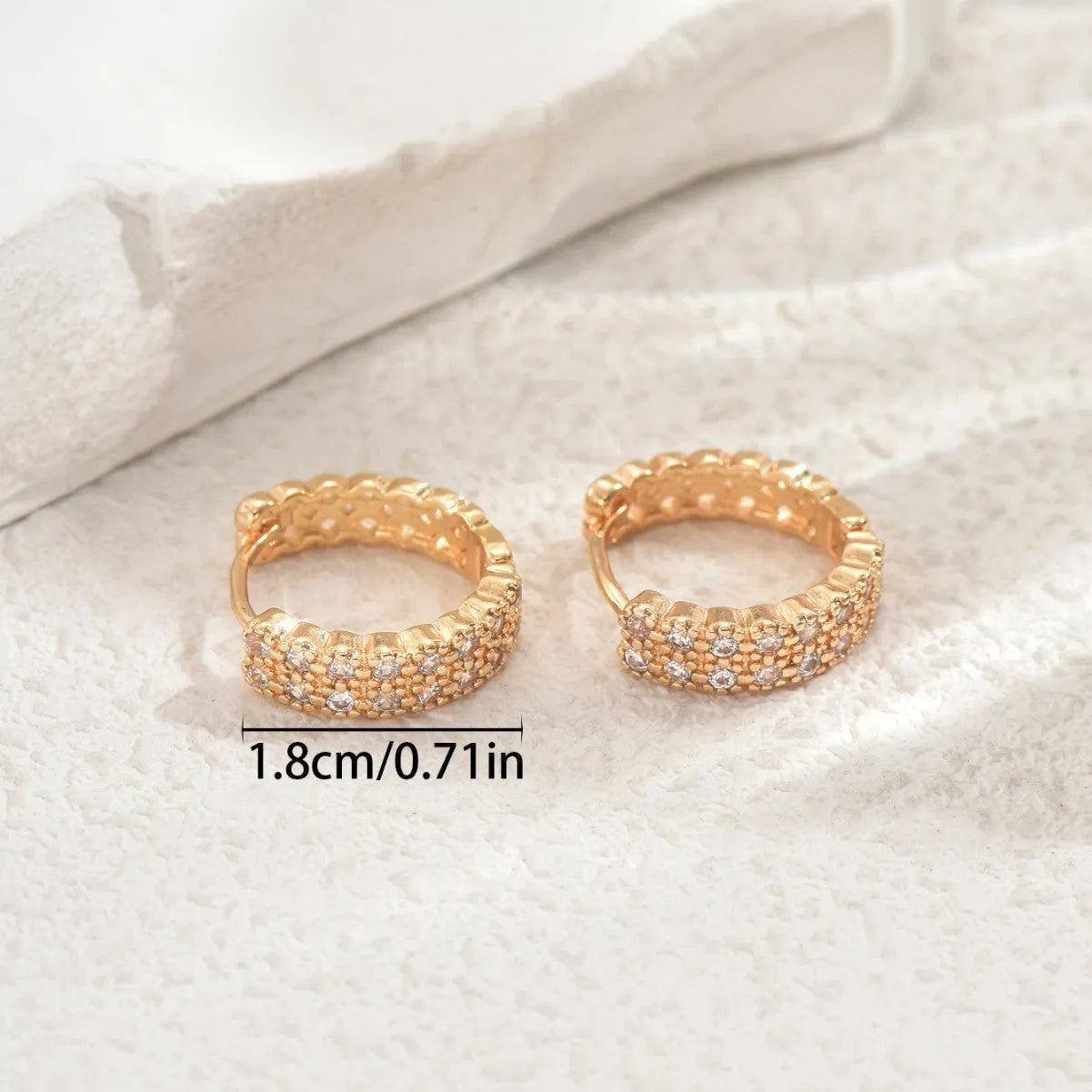 Copper geometric pattern ear studs with round, dot, and ring design elements.