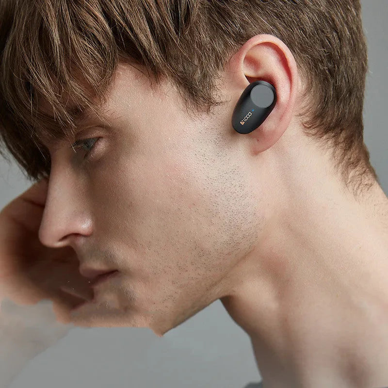 Black wireless Bluetooth headset with charging stand featuring ANC noise cancellation.