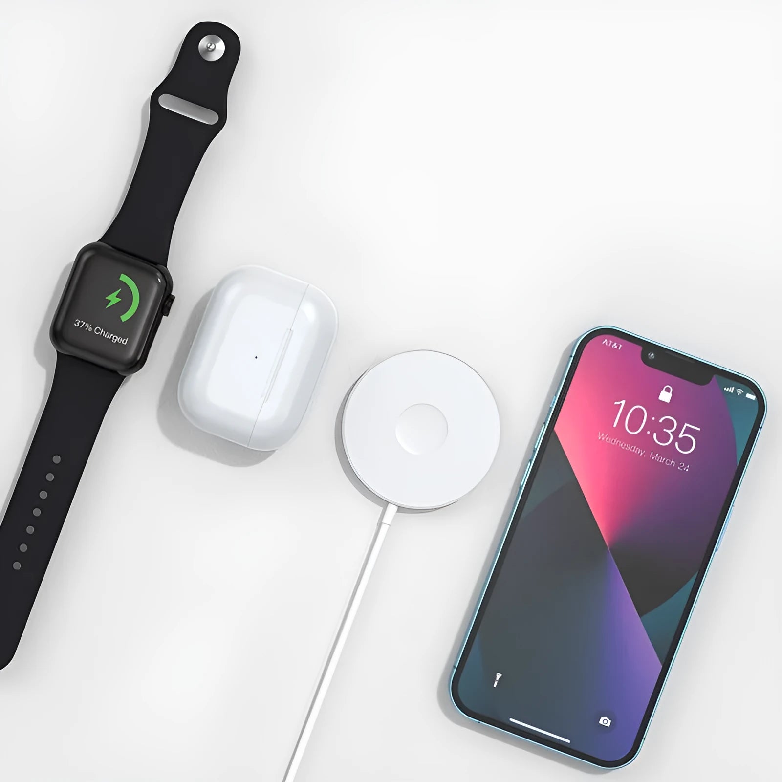 Mini magnetic three-in-one wireless charger in silver with Type-C port on desk next to devices
