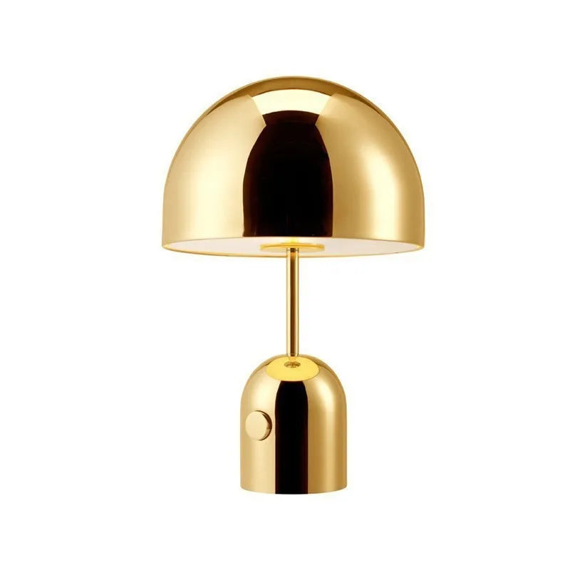 Mushroom-shaped metal table lamp in rose gold finish on wooden surface