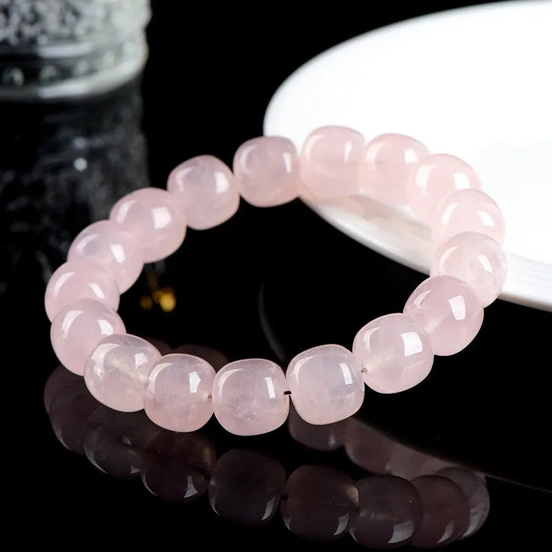 Pink crystal barrel bead bracelet with natural bamboo elements and geometric design
