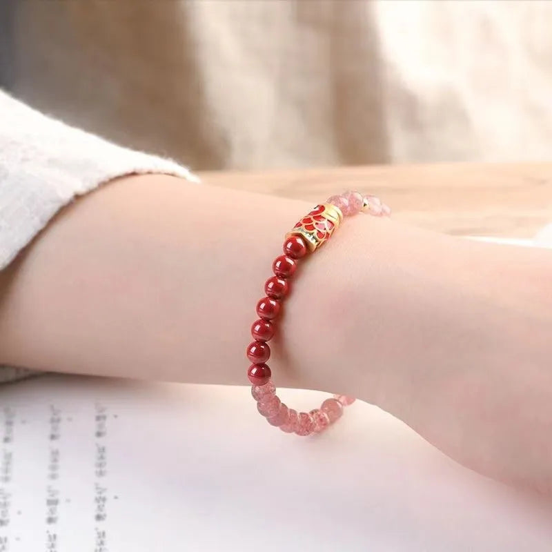 Close-up of a women's adjustable bracelet made with purple cinnabar and strawberry quartz beads in a retro style.