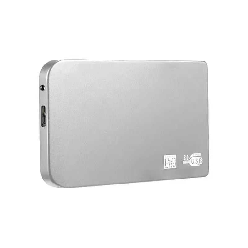Silver metal external solid state drive with USB 3.0 cable on a desk.