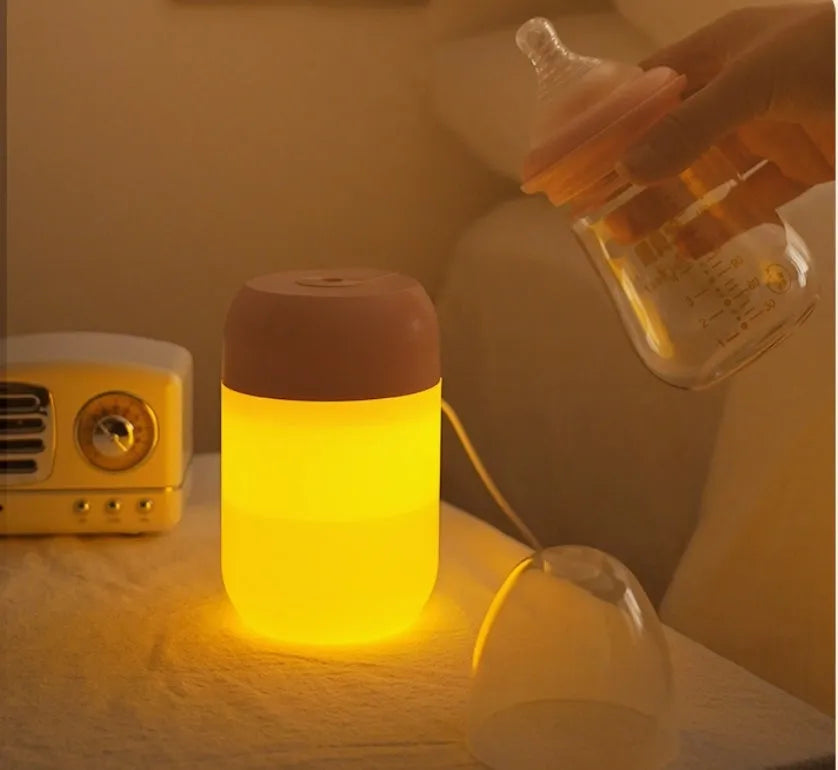 White cylindrical USB-powered mini humidifier with aromatherapy function on a desk.