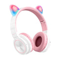 Pink and white Luminous Bluetooth wireless over-ear headset with microphone on a table.