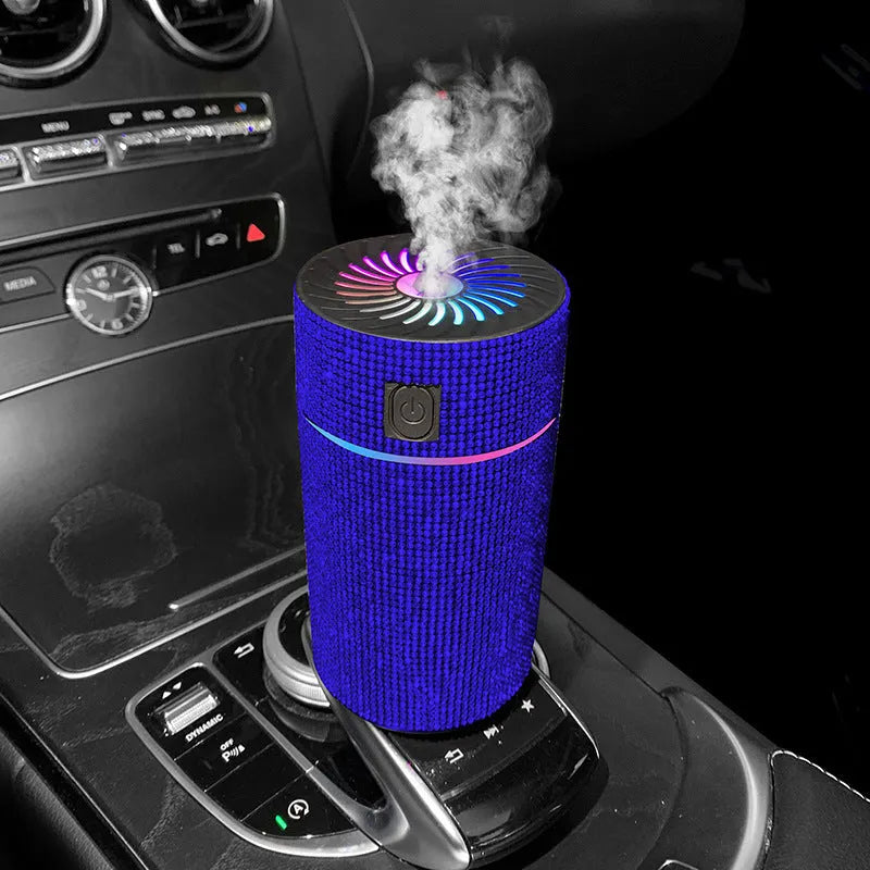 Compact white car air humidifier and purifier with USB cable on a car dashboard