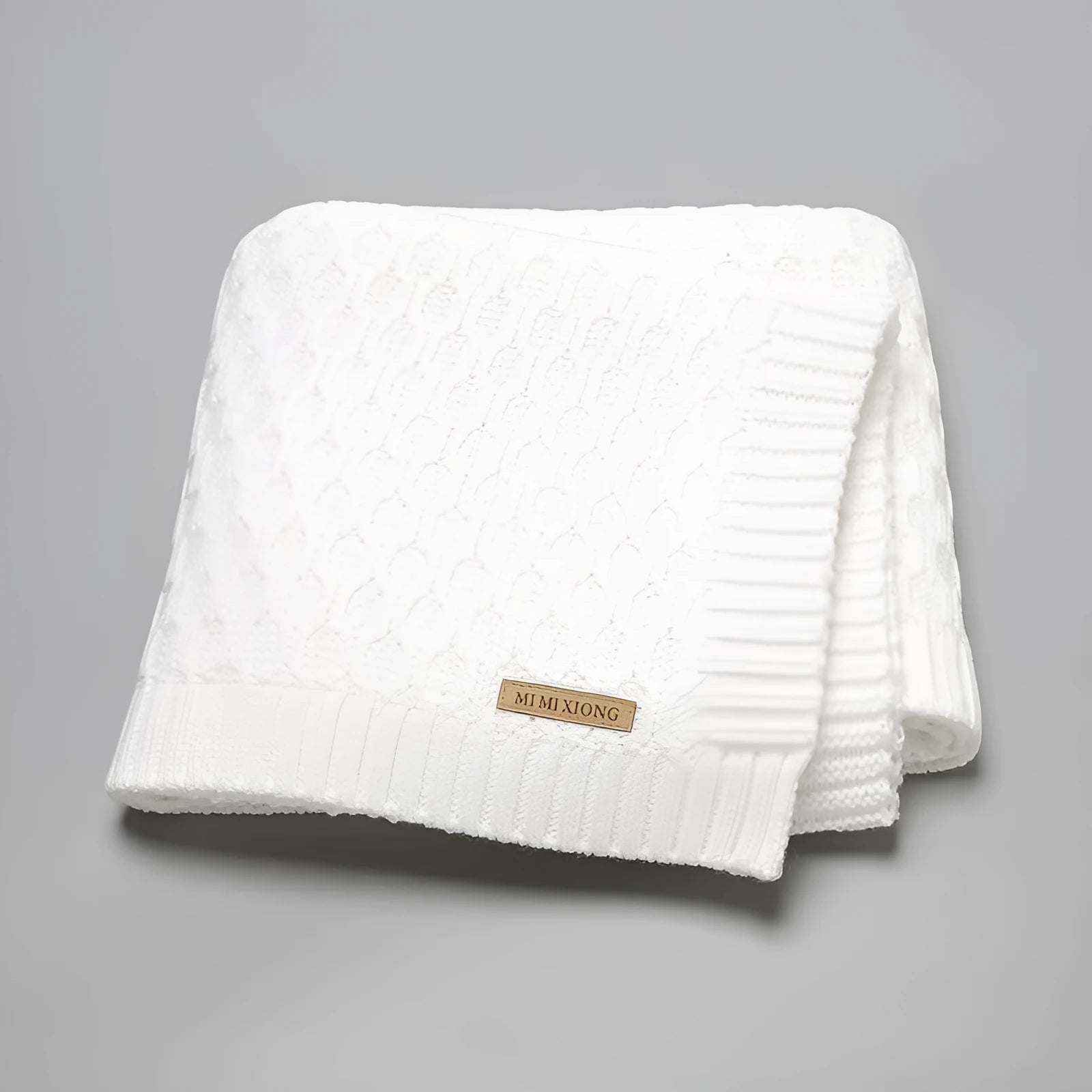 Solid-colour infant blanket with raised three-dimensional lines, shown in a light green colour.