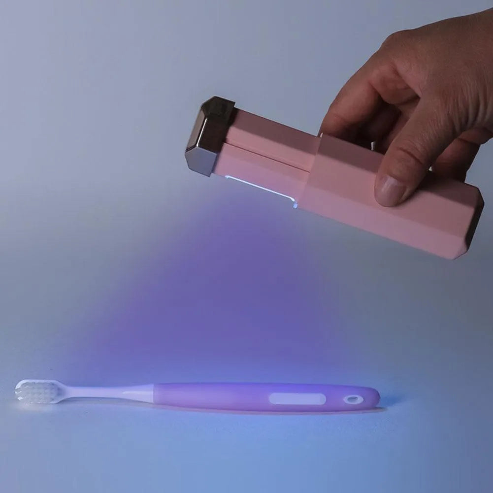 Portable UVC ozone USB germicidal wand in blue with foldable design on a table