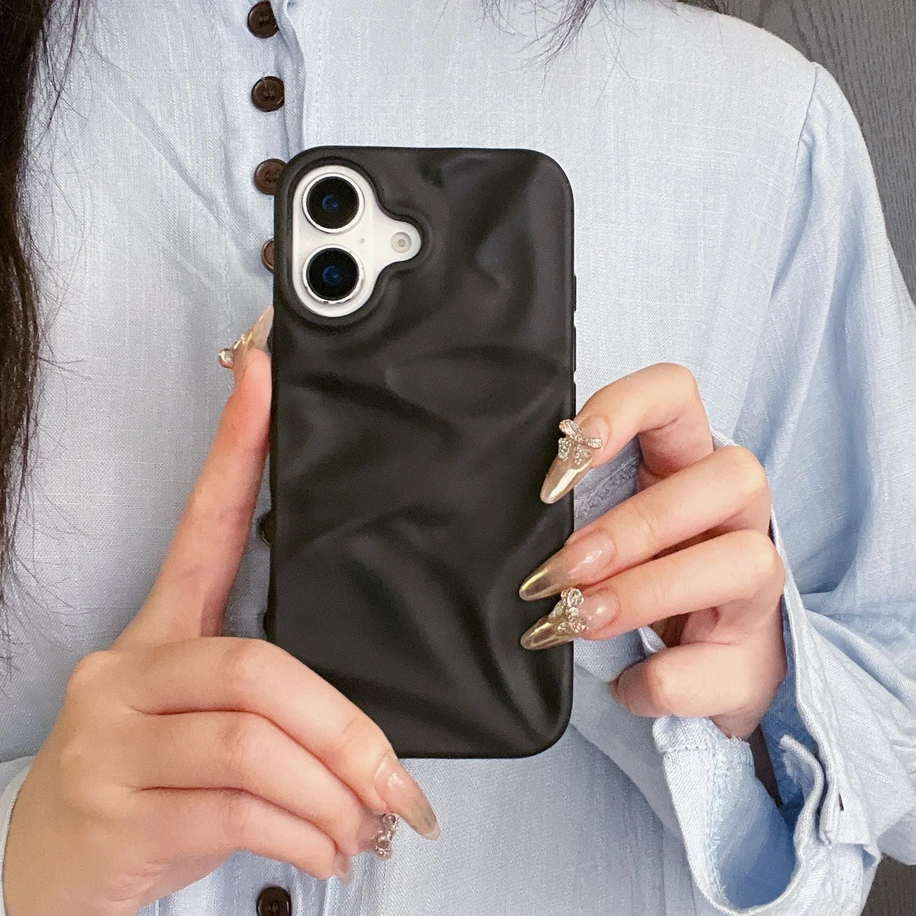 High-grade three-dimensional pleated pattern silicone phone case for iPhone 17 series in black, soft shell construction with fall protection