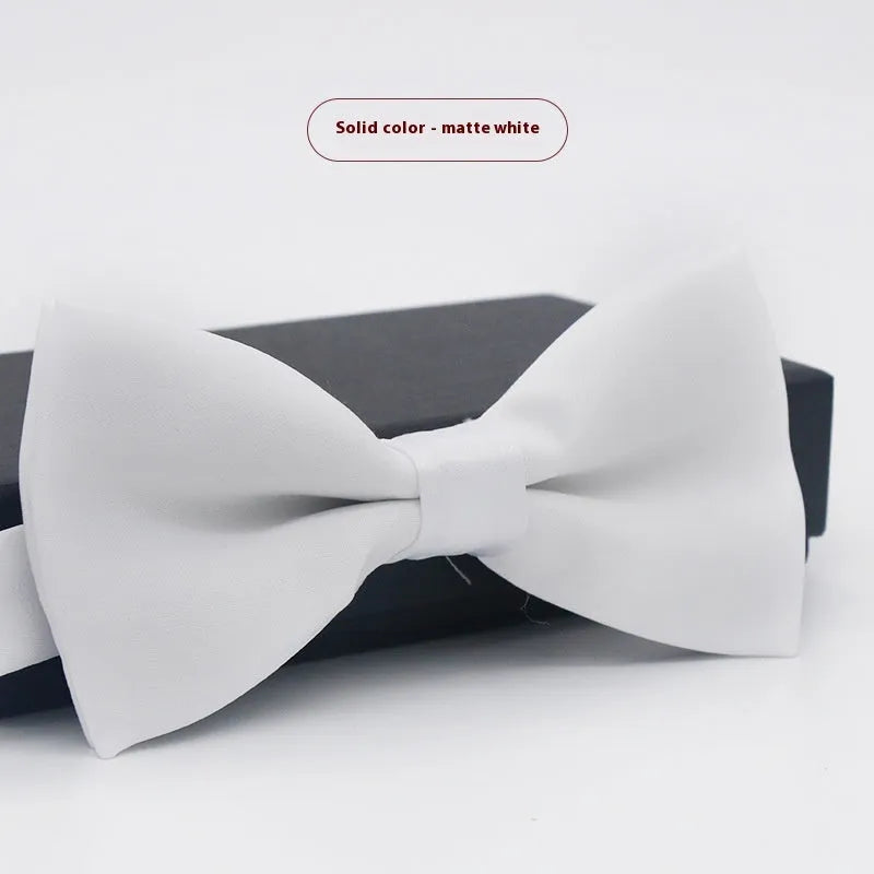 Solid colour flat head bow tie for formal wear in multiple colours including black, red, and blue.