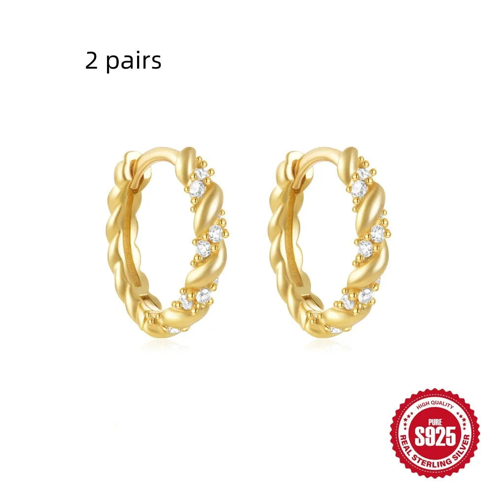 Sterling silver geometric stud earrings with round diamond accents in gold and silver electroplated finishes