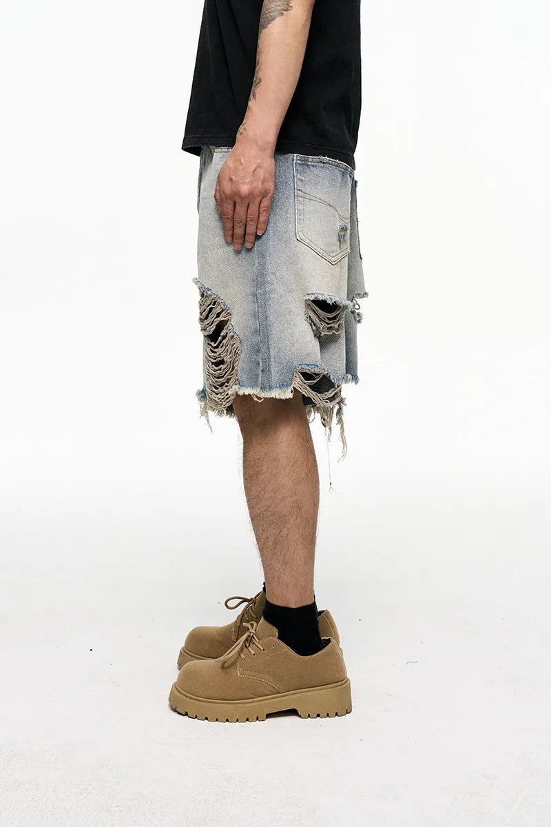Men's light blue baggy denim shorts with wide leg and retro washed finish on a mid waist.