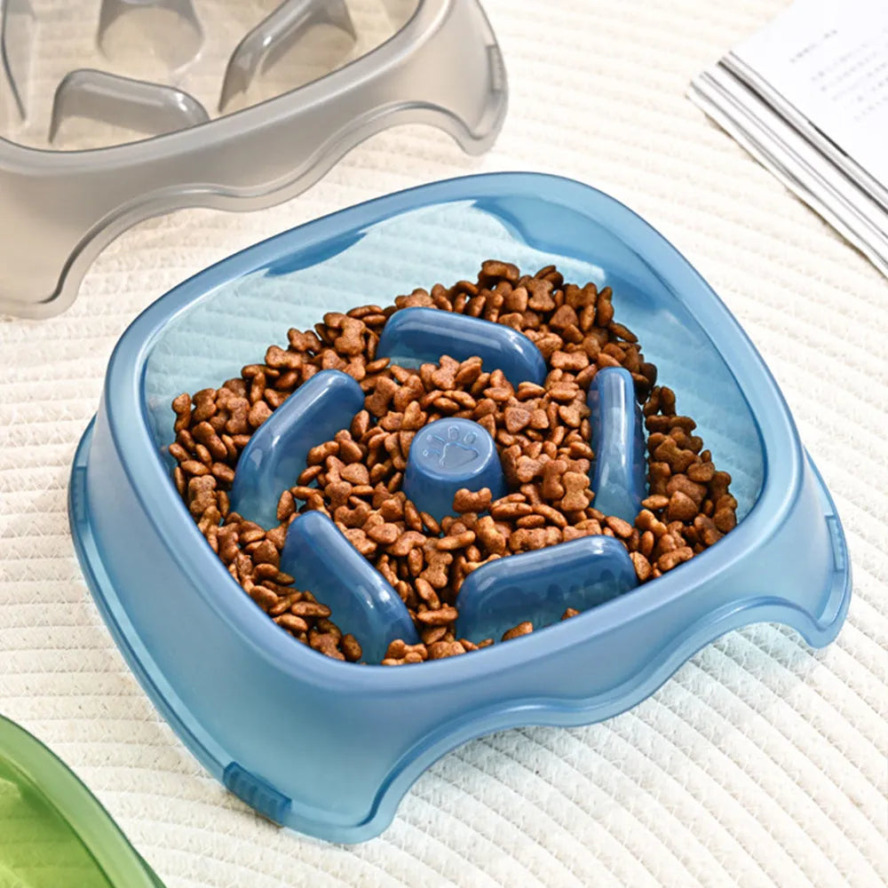 Blue plastic slow feeder dog bowl for anti-choking feeding on a plain surface.
