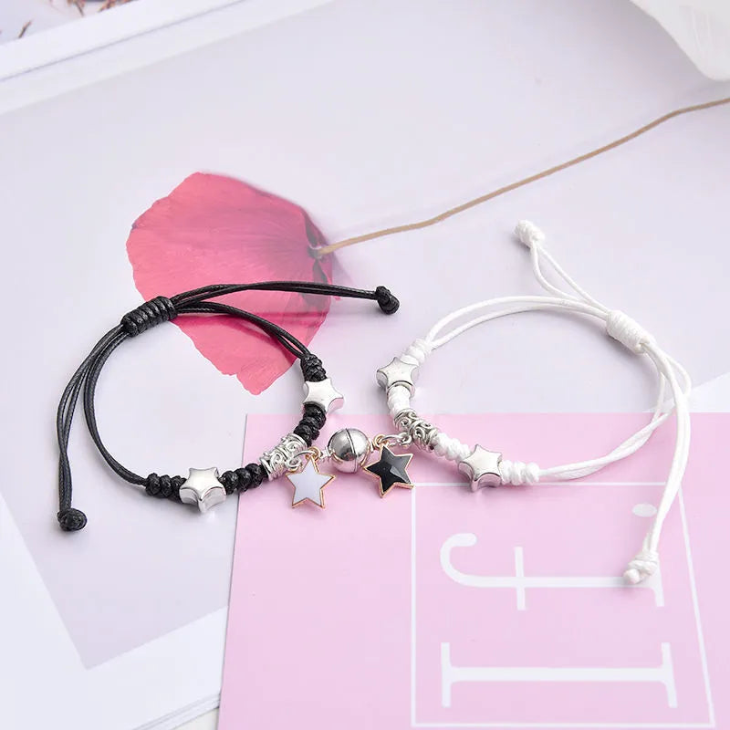 Magnetic clasp couple bracelets with alloy construction and symbolic designs including crown and love lock motifs.