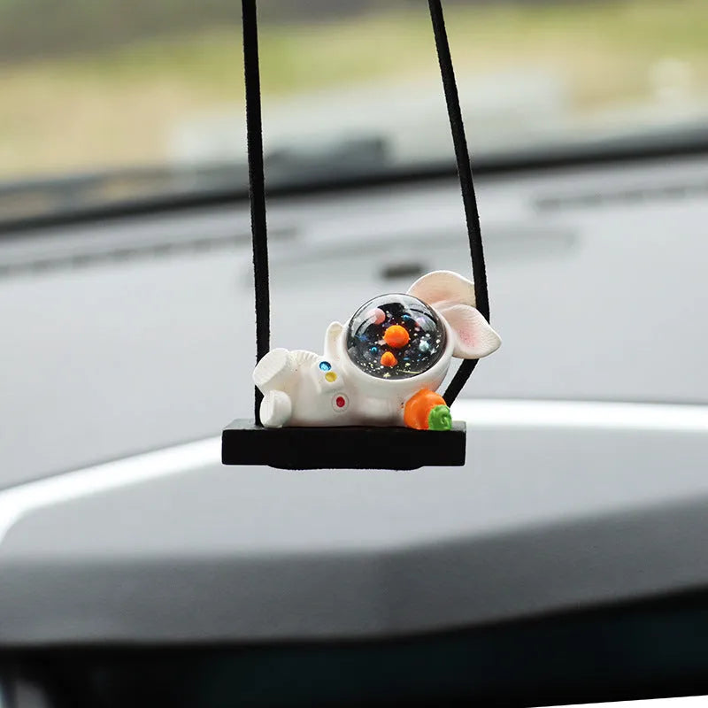 Resin cartoon astronaut car pendant decoration hanging from a rear-view mirror.