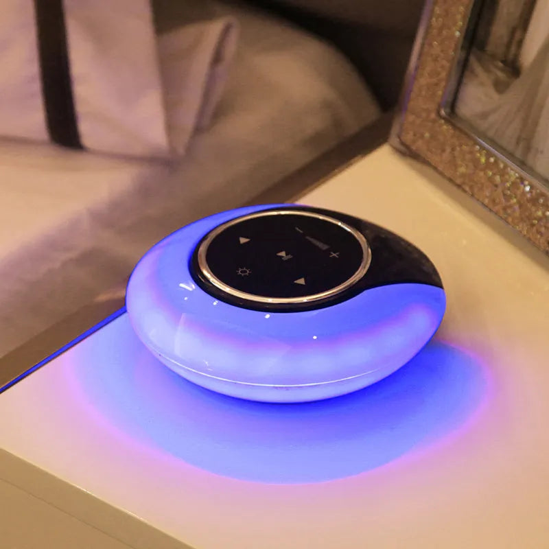 Blue folding Bluetooth speaker desk lamp with touch controls showing white, yellow, and blue LED lighting options