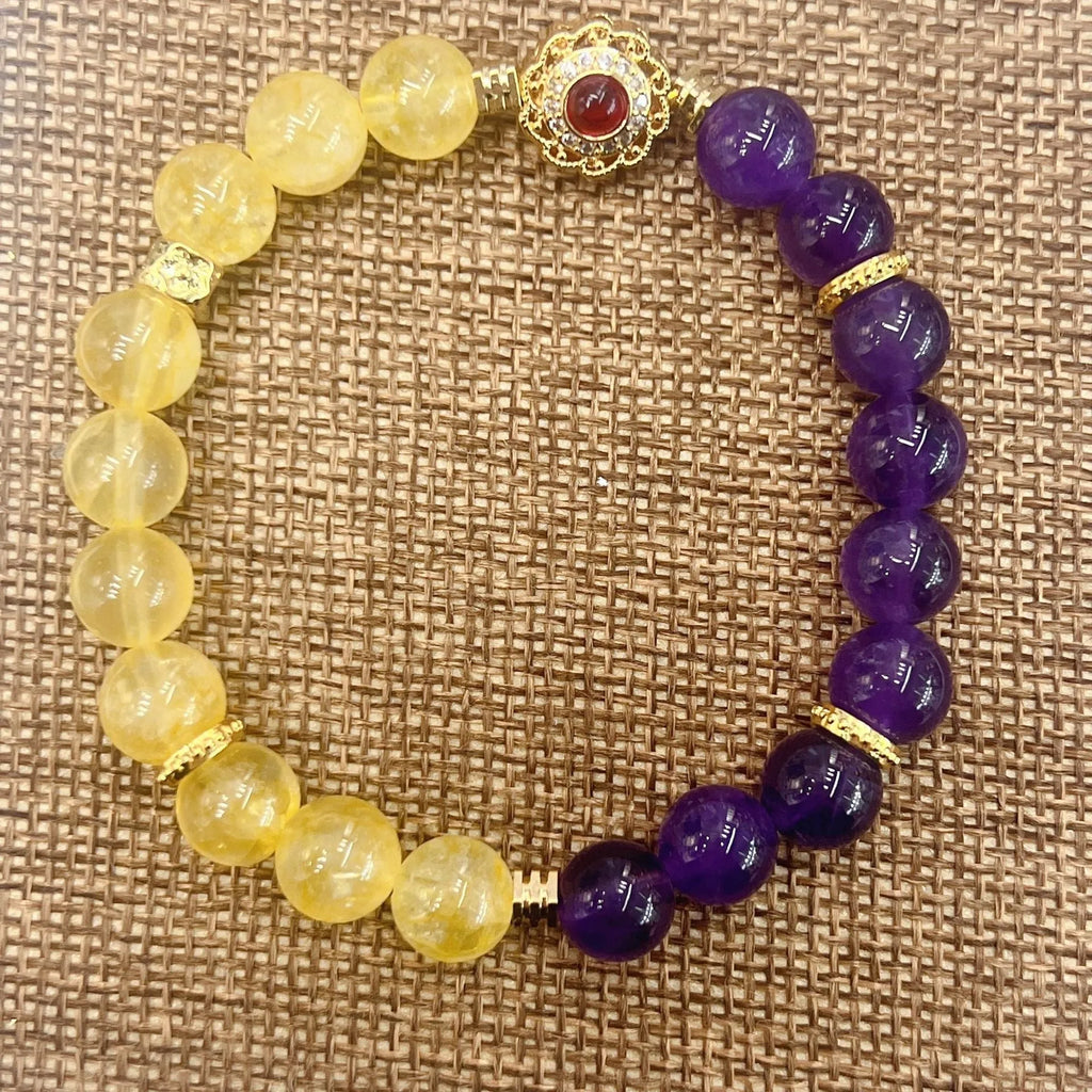 Handmade women's yellow and purple amethyst crystal bracelet on wrist