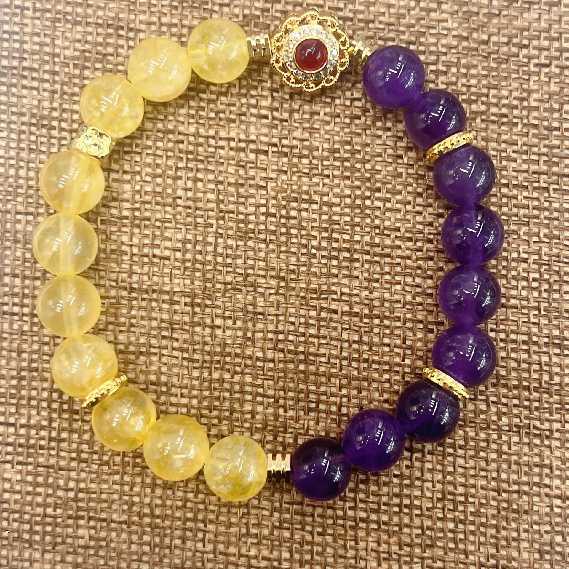 Handmade women's yellow and purple amethyst crystal bracelet on wrist
