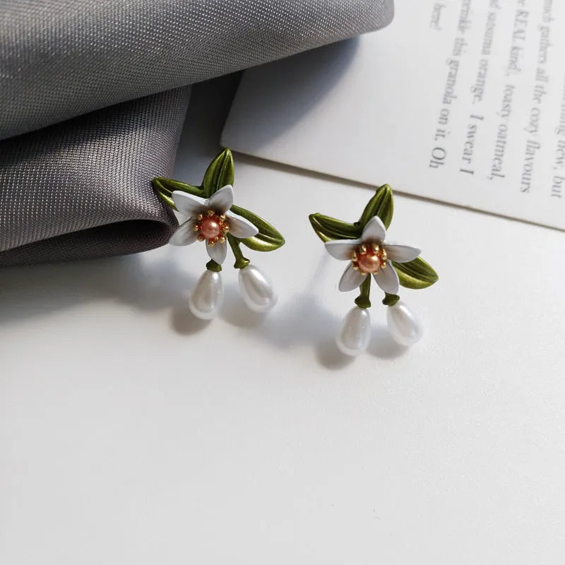 Women's contrast colour floral earrings with sterling silver needle detailing and alloy flower ear clip