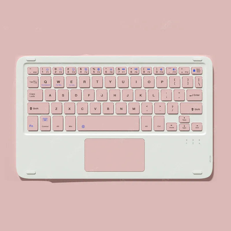 Pink Bluetooth touch keyboard and rechargeable wireless mouse on a desk next to a tablet.