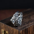 Silver open style diamond ring with a detailed jibeast and animal zodiac pattern.