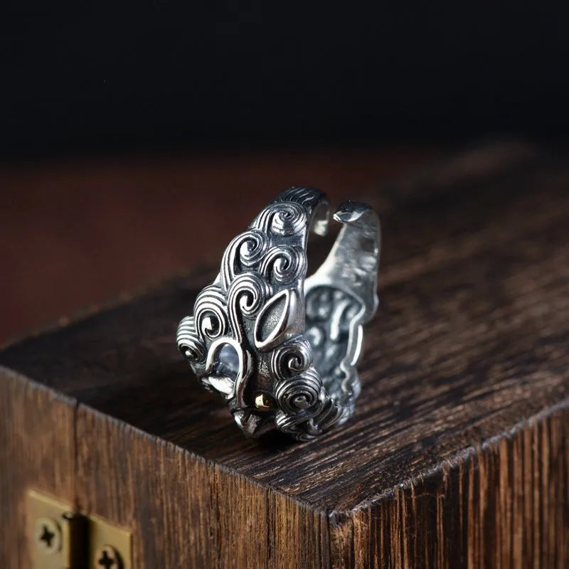 Silver open style diamond ring with a detailed jibeast and animal zodiac pattern.