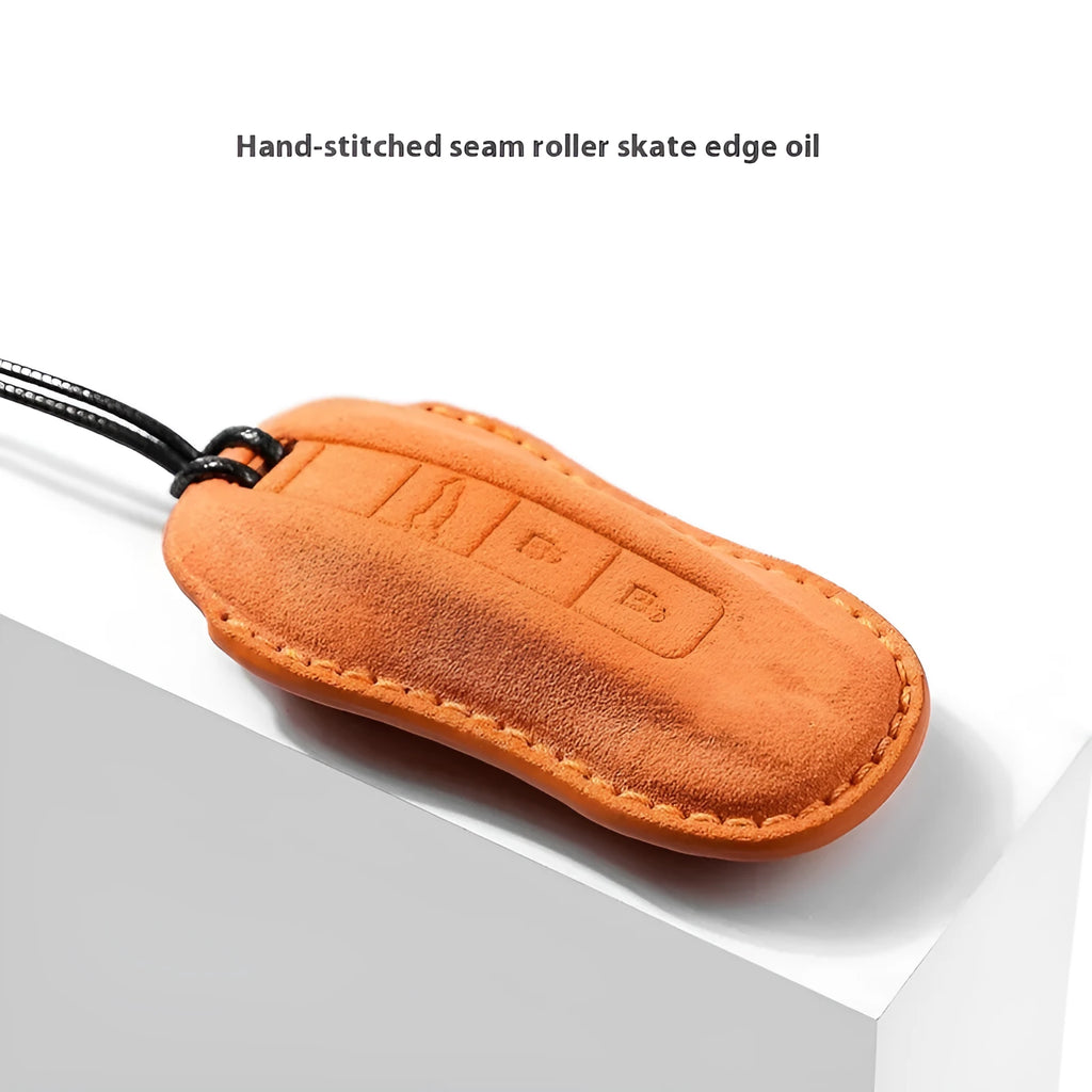 Suede car key cover in cement grey, dark green, light grey, and orange colour options.